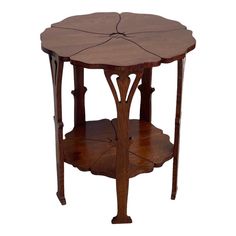 a wooden table with an intricate design on the top and bottom shelf, sitting against a white background