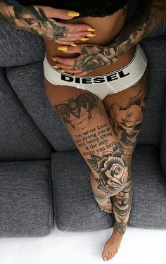 a woman with tattoos on her body and legs