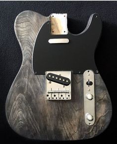 an electric guitar that is made out of wood and has metal parts attached to it