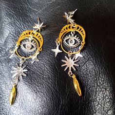 These Are New And Fun Silver And Gold Alloy Star And Seeing Eye Earrings. These Are Really Lightweight With Hypoallergenic Posts. These Are Over 2" Long. Please Ask Questions And Make An Offer. I Can't Say Yes If You Don't Ask! Celestial Silver Earrings With Star Charm, Celestial Style Silver Jewelry, Silver Star-shaped Jewelry With Dangling Charms, Silver Star-shaped Metal Jewelry, Silver Star Shaped Metal Jewelry, Star Shaped Silver Metal Jewelry, Pierced Star-shaped Metal Earrings, Party Earrings With Star Charm In Metal, Pierced Metal Star Earrings