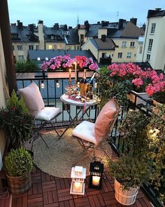 the balcony is decorated with potted plants, candles and other things to enjoy in