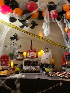 a table topped with lots of food and balloons