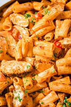 pasta with chicken and tomatoes in a skillet