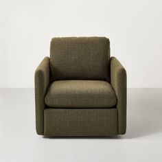 a green chair sitting on top of a white floor