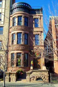 an old building with many windows on the corner