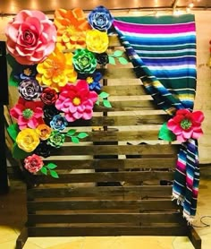 a wooden pallet with flowers on it and a striped towel hanging from the side