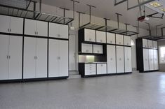 an empty room with white cabinets and black accents on the walls is pictured in this image