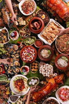 many different types of food are spread out on the table to be served at a party