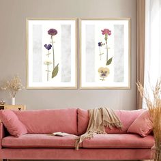 two paintings on the wall above a pink couch