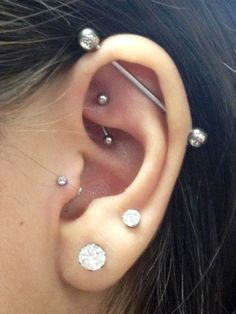 a woman with three piercings on her ear