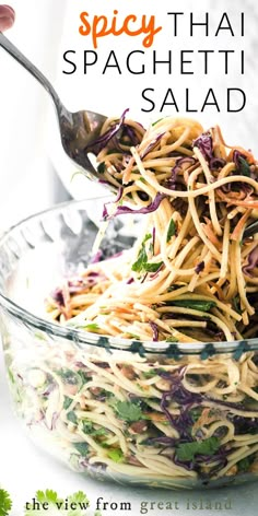 the cover of spicy thai spaghetti salad is being spooned into a large glass bowl