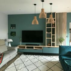 a living room filled with furniture and a flat screen tv on top of a wooden entertainment center