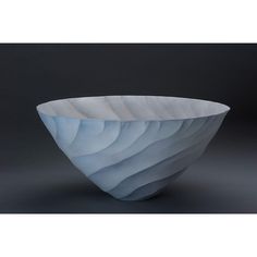 a white and blue bowl sitting on top of a table