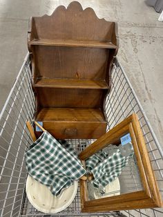 an empty shopping cart filled with dishes and other items