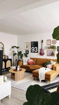 a living room filled with furniture and plants