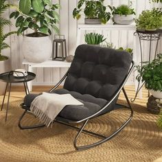 a living room with potted plants and a rocking chair