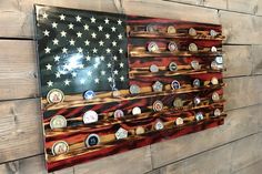 an american flag made out of buttons on a wooden wall with wood planks behind it