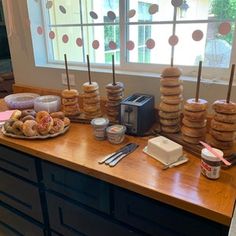 an assortment of desserts and pastries on a counter in front of a window