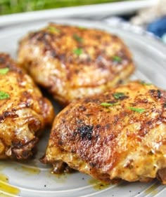 three pieces of chicken sitting on top of a plate