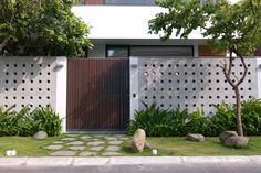 a modern house with an entrance and landscaping