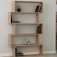 a bookshelf in the corner of a room with a brick wall behind it