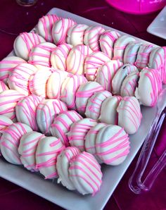 pink and white striped candy balls on a plate with the caption pint to win