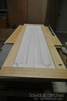 an unfinished cabinet door is being assembled on a table