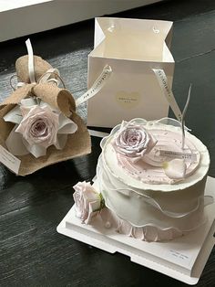 two wedding cakes in boxes on a table