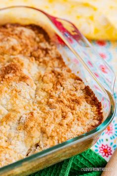 a casserole dish filled with some type of baked food on a colorful cloth