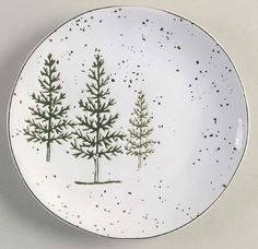 a white plate with green trees on it