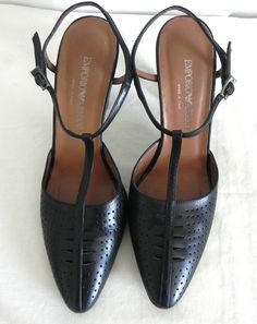 Emporio Armani Pumps                                                              . Material -  Leather                                     . Lining -   Yes                                     . Color –   Black                                     . Closure –  T-Strap with Buckle                                     . Style –   Pumps                                       . Size –  37.5                                 Please see photos. Formal T-strap Heels With Branded Heel Counter, T-strap Heels With Heel Loop For Formal Occasions, Leather T-strap Slingback Pumps For Formal Occasions, Formal T-strap Heels With Padded Heel, Classic T-strap Heels For Formal Occasions, Formal T-strap Heels With Buckle Closure, Vintage Heels With Buckle Closure For Evening, Vintage T-strap Heels For Evening, Vintage Evening Heels With Buckle Closure