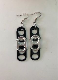 Earrings made from upcycled black and silver pop tabs with silver ear wire. Diy Earrings Out Of Random Things, Pop Tab Earrings, Pop Tab Crafts Easy, Pop Tabs Crafts, Pull Tab Crafts, Pop Tab Jewelry, Can Tab Earrings, Soda Tab Earrings, Tab Earrings