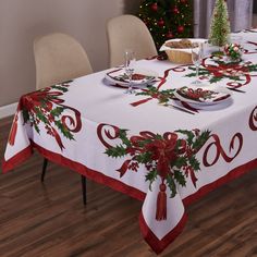 the table is decorated with holly and red ribbon