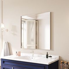 a bathroom vanity with two sinks and a large mirror