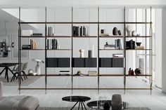 a living room filled with furniture and bookshelves next to a dining room table