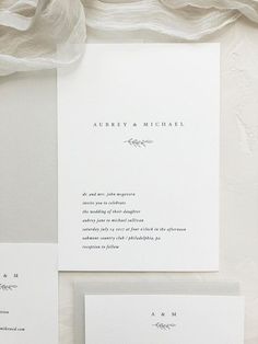 the wedding stationery is laid out on top of each other