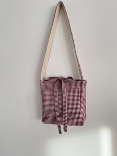 a red and white checkered bag hanging on the wall