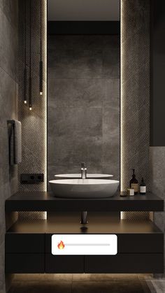 a bathroom with a sink, mirror and lights on the wall above it's counter