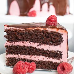 a slice of chocolate cake with raspberries on top