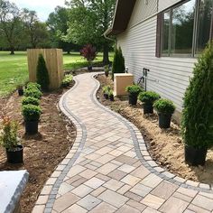 a brick walkway in front of a house