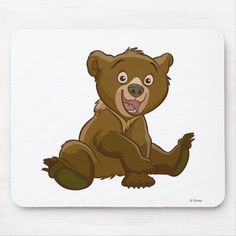 a cartoon bear sitting on the ground with its mouth open mousepads, which have been designed to look like a brown bear