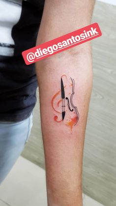 a person with a tattoo on their arm holding a knife and musical notes in the shape of a violin