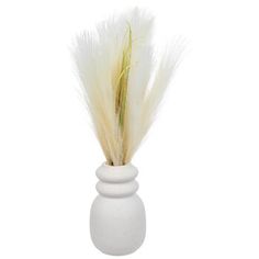 a white vase with some grass in it