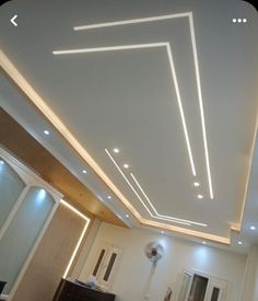 an empty room with white walls and lights on the ceiling is pictured in this image