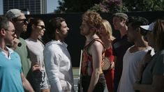 a group of people standing next to each other on a tennis court