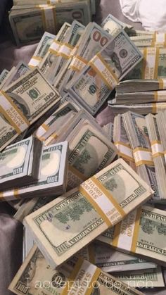 a pile of money sitting on top of a bed