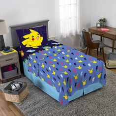 a child's bedroom with a bed, desk and chair in the corner that has a pokemon comforter on it