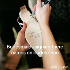 a person holding a shoe with writing on it and the caption reads, bridesmaids signing there names on shoes shoe