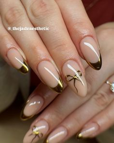 little golden bows & french tips, ✨🫶🏼 gel fill on natural nails w/ hand painted nail art <3 @stellar_gel - stellar bond - hard structure gel natural - stellar black - stellar matte top - stellar shine top @dndgel - dnd 871 how do u neutral? @the_gelbottle_inc - 2 in 1 base #chrometips #chromefrenchtips #goldfrenchtips #goldtips #goldbow #bownails #coquettenails #goldnails #goldchromenails #goldchrome #coquetteaesthetic #coquettefashion #nails #thenailawards #nailsnailsnails #nailsofin... Gold Texture Nails, Natural Nails Gold Accent, Half Gold Nails, Gold Ribbon Nails, Gold French Tip Christmas Nails, Basic Gel X Nails, Gold Nail Inspo Almond, Gold Edge Nails, Almond Nails Gold Tips