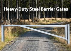 an open gate on the side of a dirt road with trees in the background and text heavy duty steel barrier gates